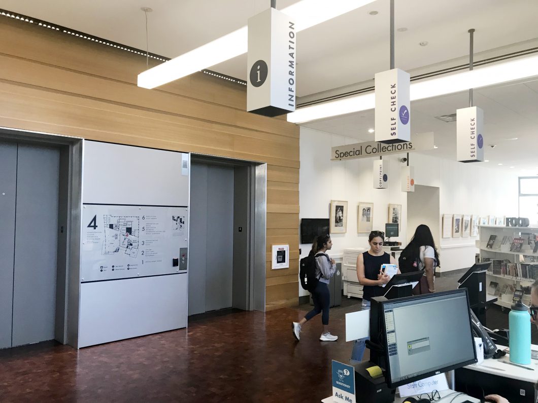 Informative signage makes the library easy to navigate and accessible. Universal icons are used to communicate to all language speakers. (Austin Central Public Library)