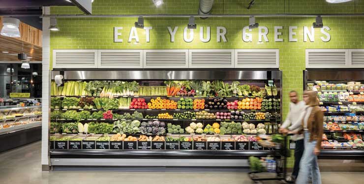 people walking in grocery store aisle