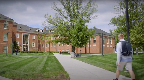 Student walking on sidewalk at Miami University Shideler Hall