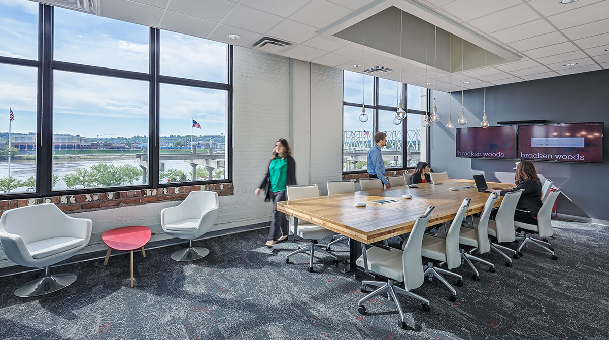 Employees gather around a conference table