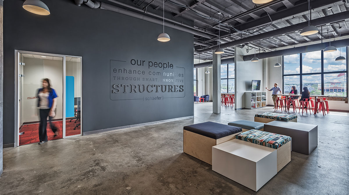 Experiential graphic design on the wall reminds employees of their impact on the community