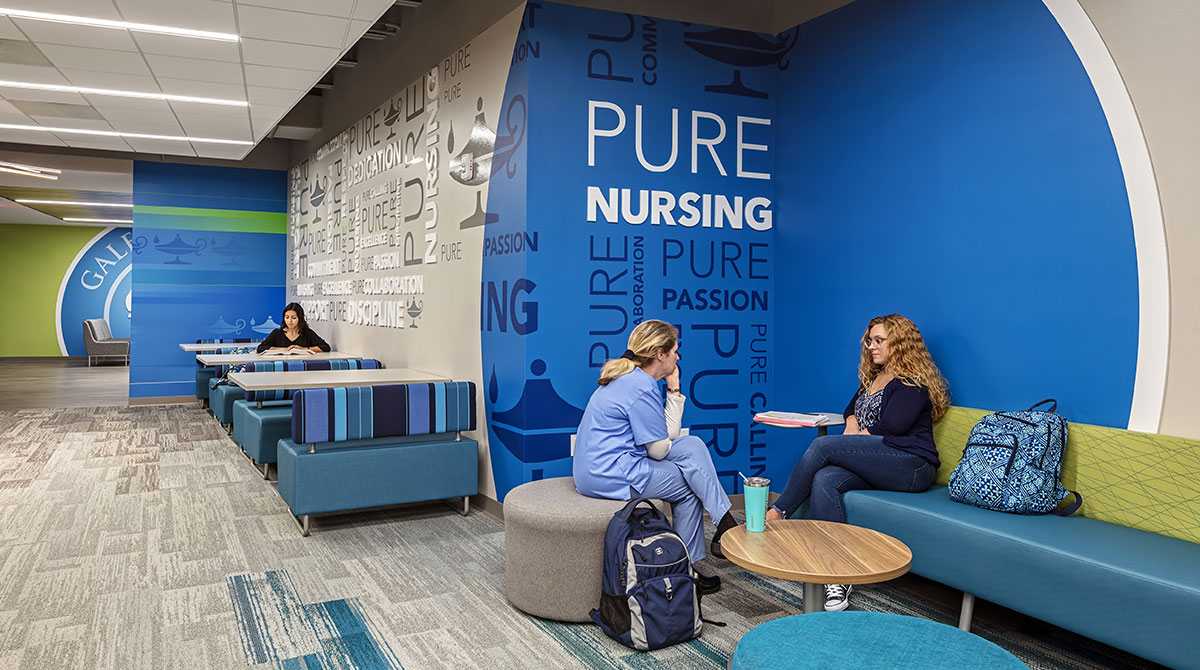 Informal collaboration spaces with a "Pure Nursing" graphic on the wall