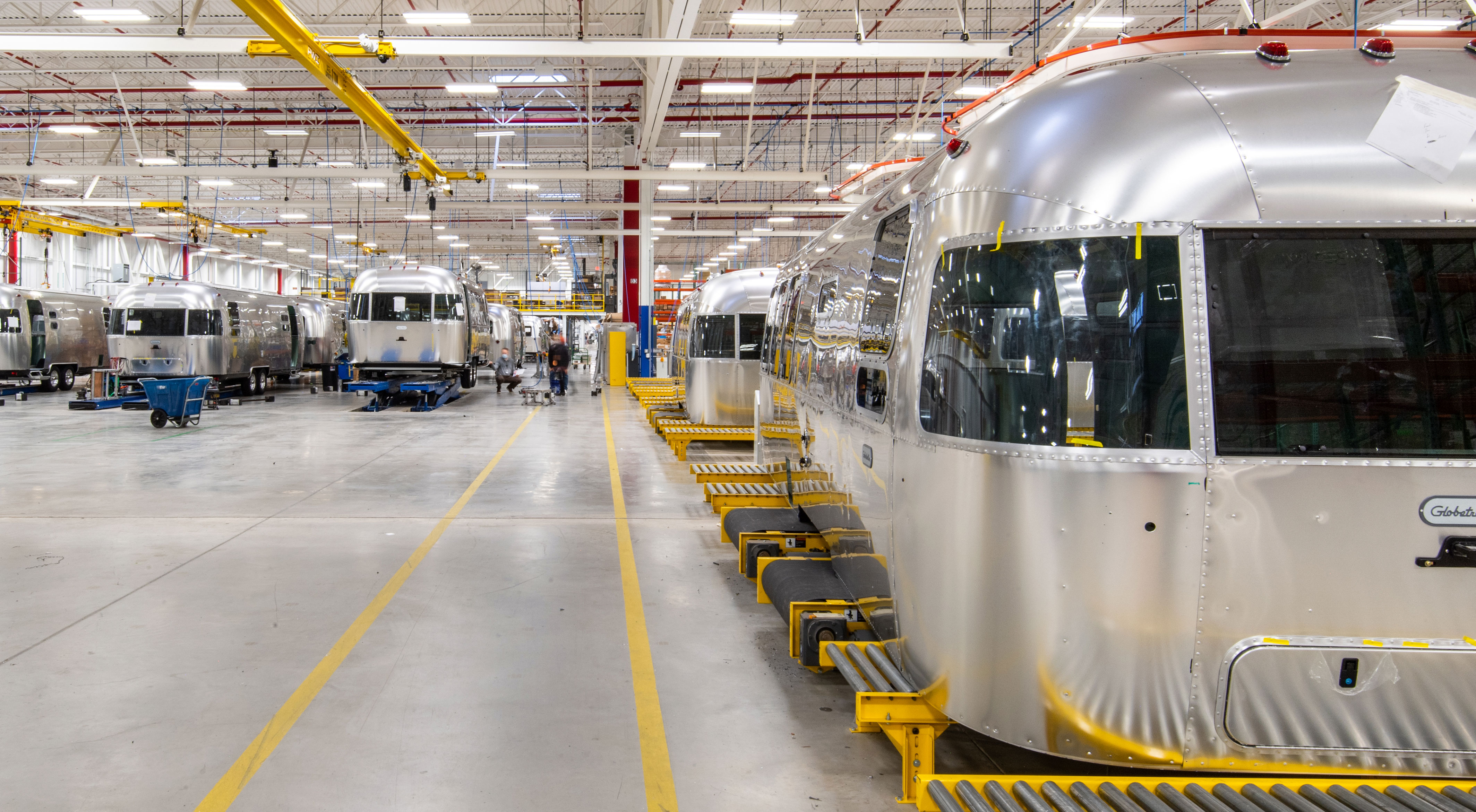 Multiple Airstreams are shown being worked on by employees