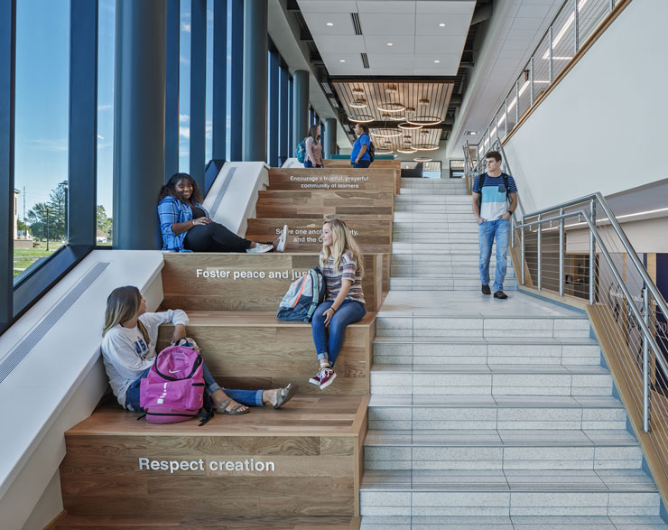 Students sitting on the steps of University of Saint Francis' Achatz Hall