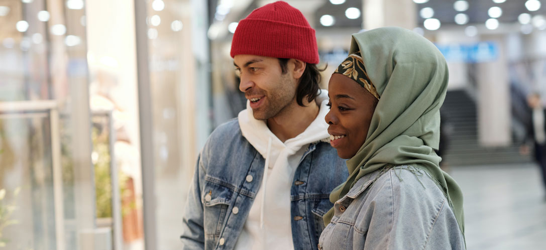 Two shoppers looking at retail window display