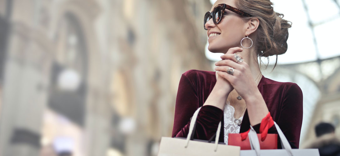 Woman holding shopping bags in retail center