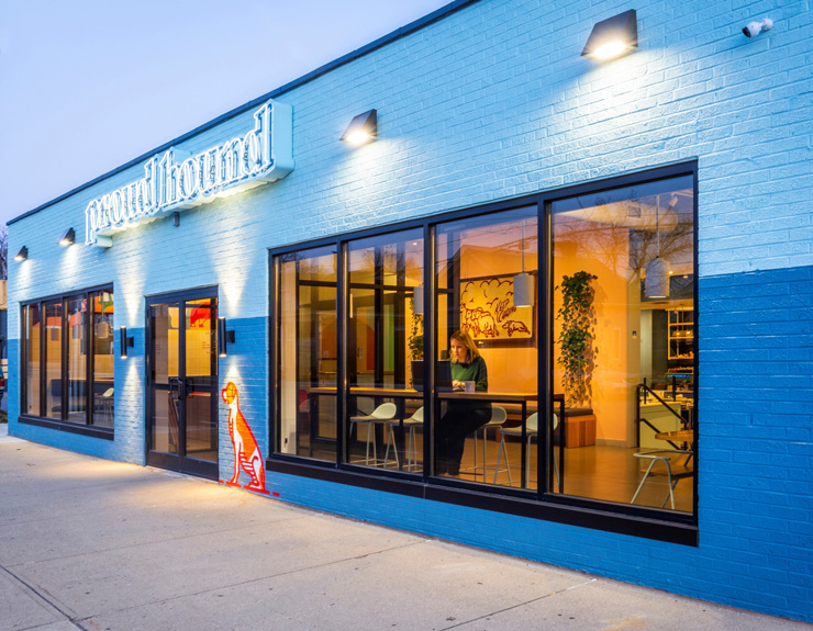 Image of windows on Proud Hound exterior with view of the coffee shop interior