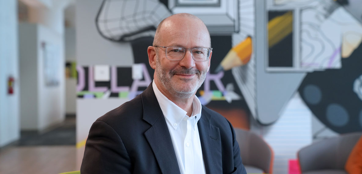 Company headshot of Steve Hackman with artistic mural background