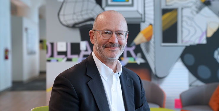 Company headshot of Steve Hackman with artistic mural background