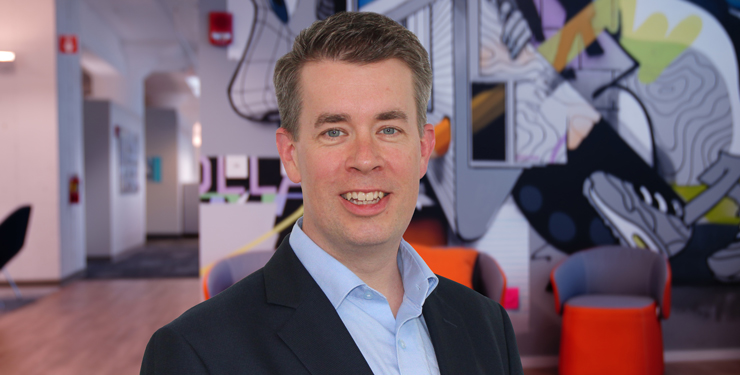 Company headshot of Michael Garvey with artistic mural background