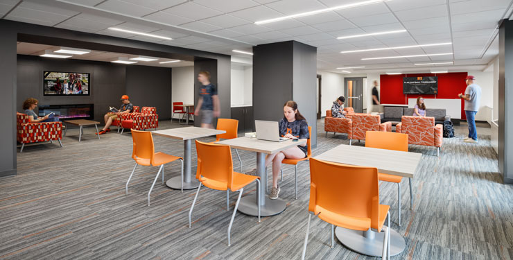 Students working and hanging out in commons area of Miller Hall at Heidelberg University.