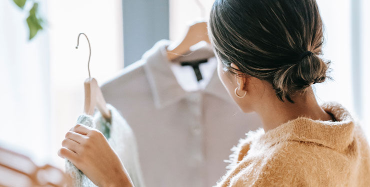 Woman shopping and choosing between two shirts