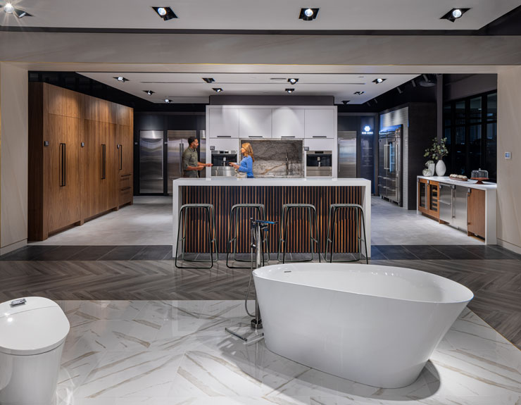 Customer and architect conversing in a kitchen display at Ferguson Studio Showroom