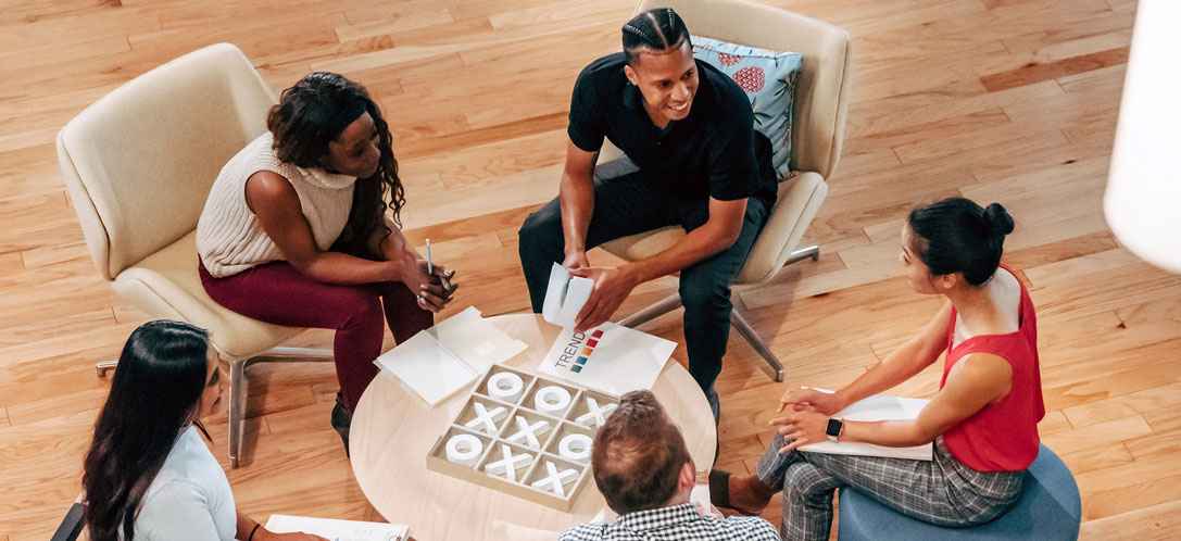 Four people working in the pharma industry meeting to discuss a project