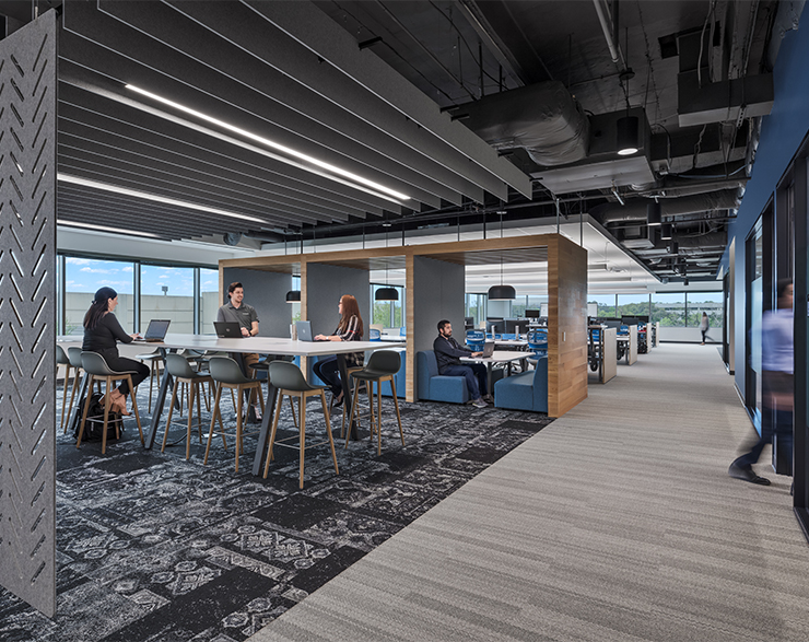 Open table cubicles give employees the feeling of privacy while also being able to collaborate with those around them.