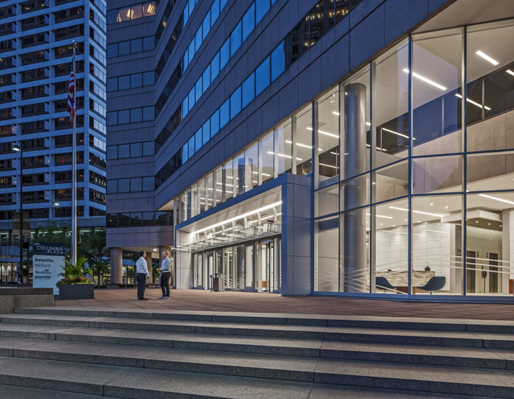 Two people talking outside of the Columbia Plaza Lobby