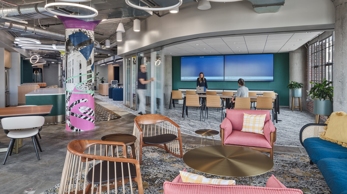 The Talent Magnet is furnished with plenty of comfy seating space and tables. Columns throughout the space add a pop of color to the muted space.