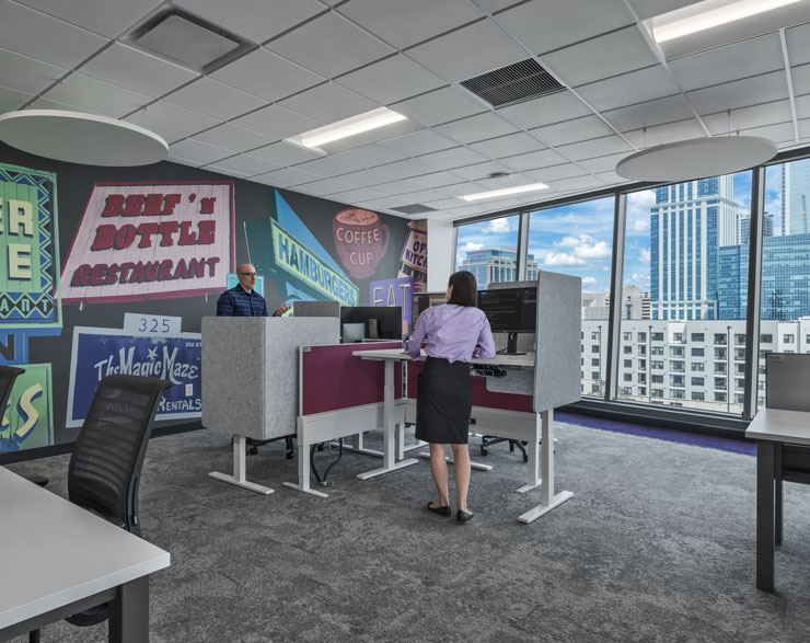 Employees using standing desks in WTW's Charlotte office