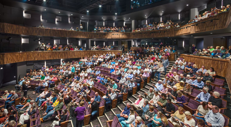 People gathering in the new theater at Playhouse in the Park before a show