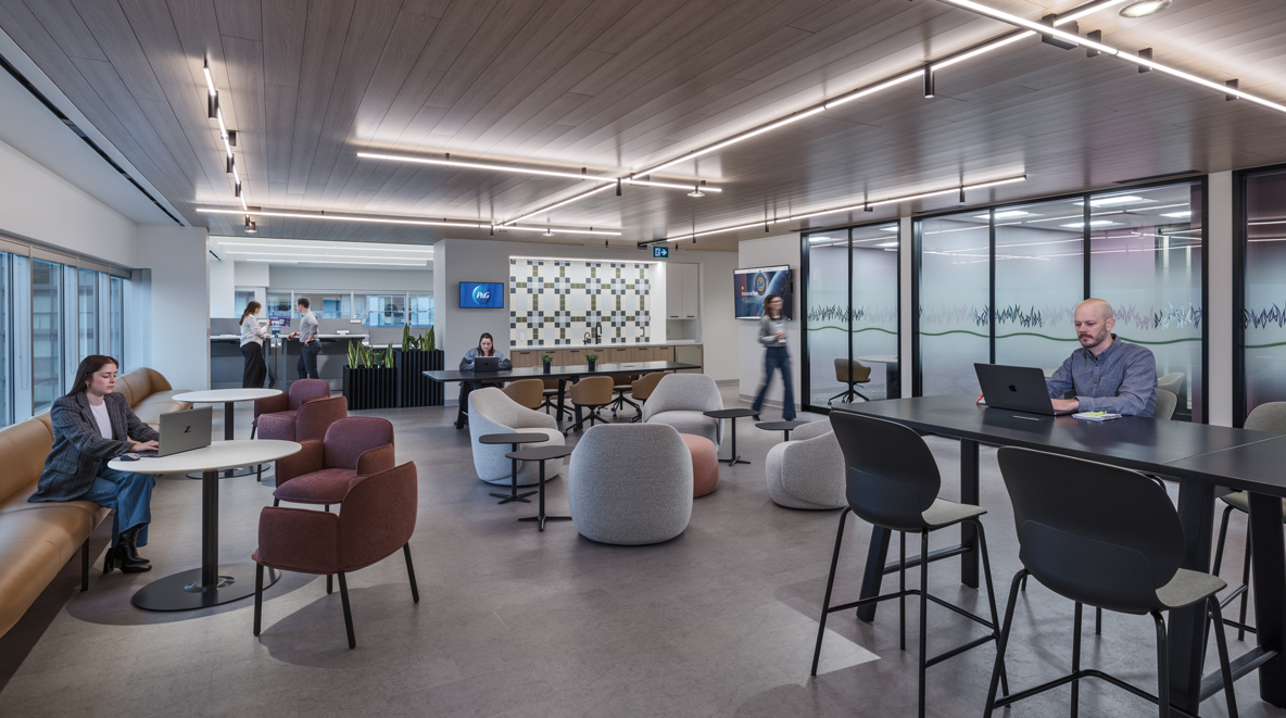 Employees are shown working together or solo in a commons area