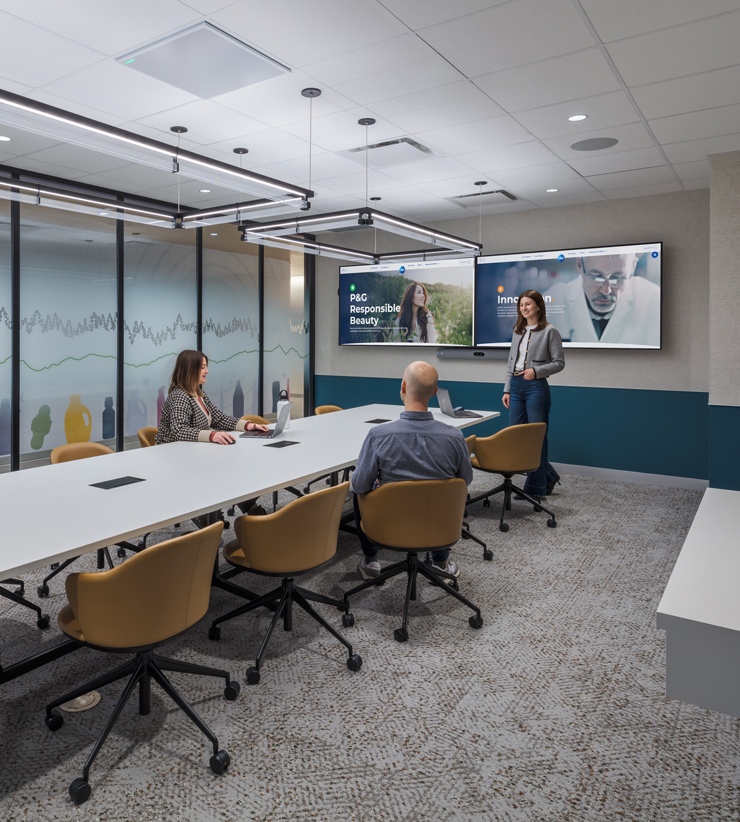 Employees meet together in a conference room