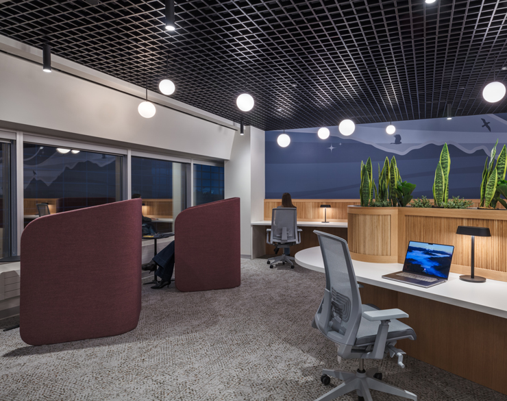 A heads-down work area is shown with dim lighting and wood tones