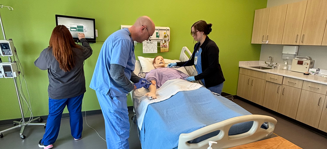 Student practice checking vital signs on a simulated patient