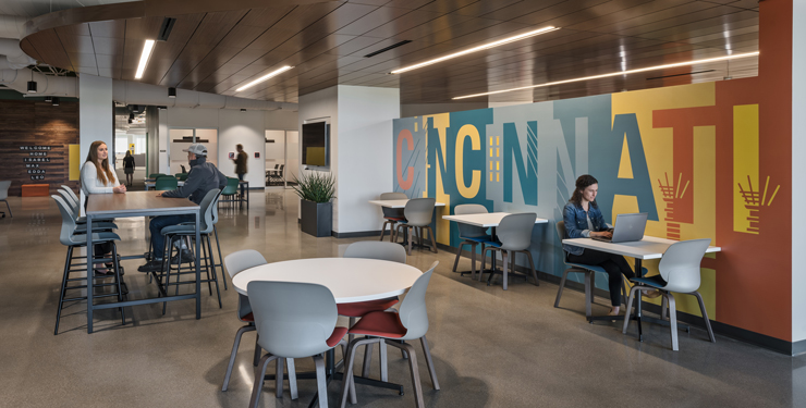 A graphic displaying "Cincinnati" is shown in the background of an employee common area