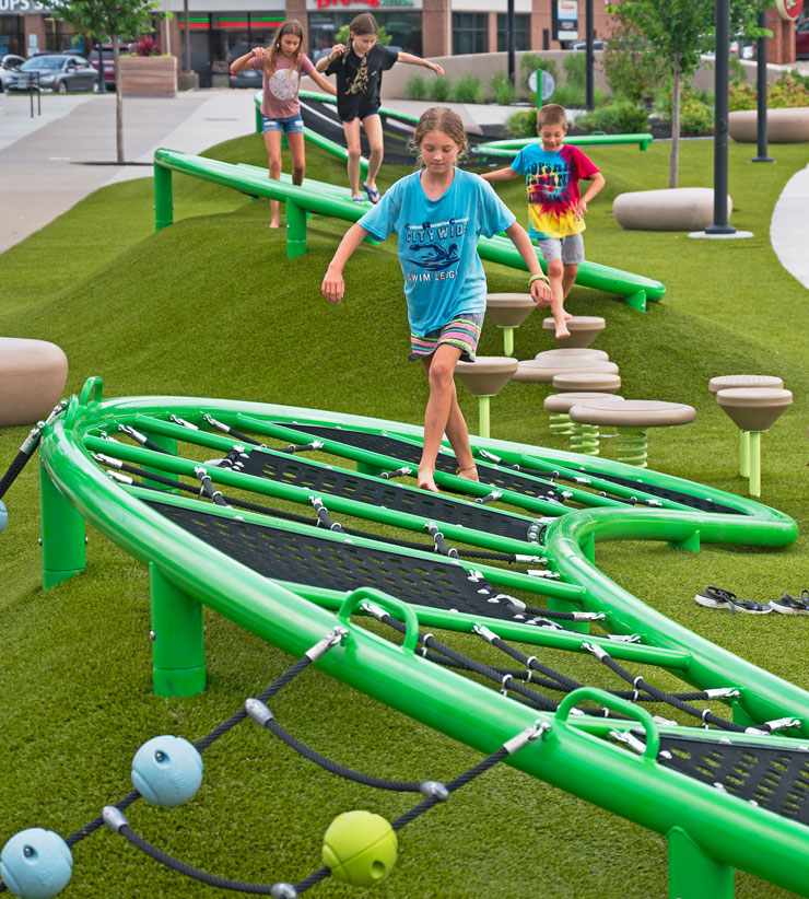 kids using the new playground within the blue ash towne square