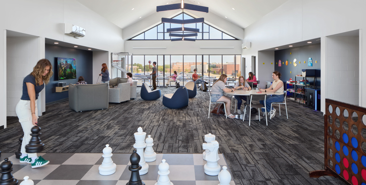 Students hang out in small groups on the third floor of the new residence hall