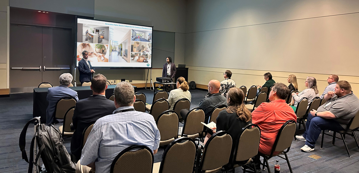 Mike Garvey and Alejandro J. Medina presenting in front of a crowd