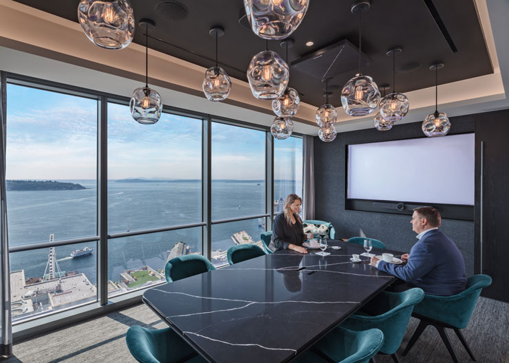 Two people in a medium size meeting room