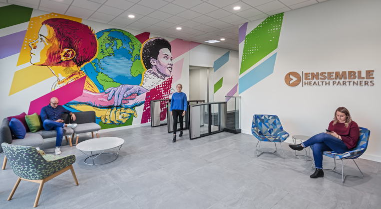 A large mural is shown at the entrance of a facility