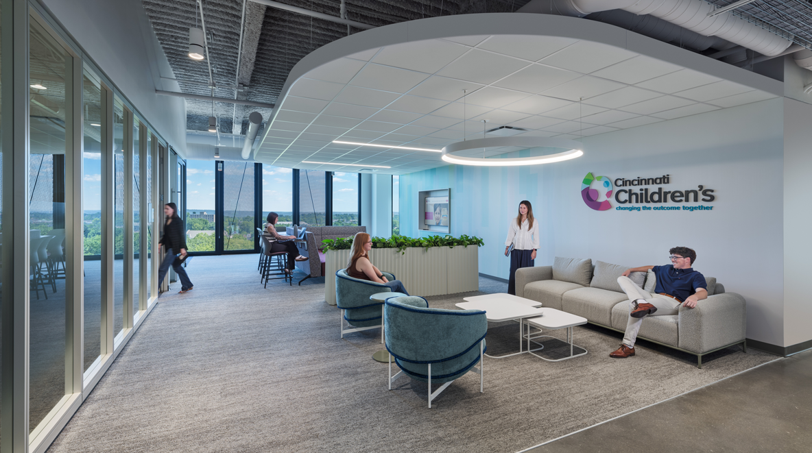 people sitting near Cincinnati Children's sign