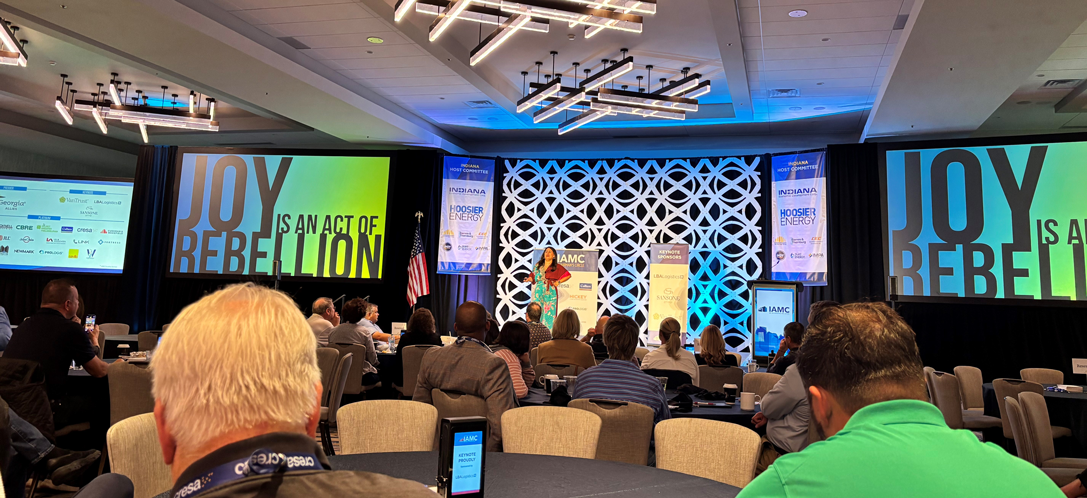 someone on the stage and people in seats