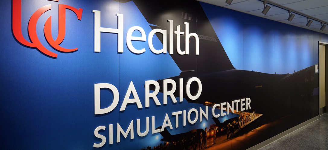 A C-17 Globemaster with Wright-Patterson Air Force Base tail markings, service members, and medical teams boarding with wounded at dusk.