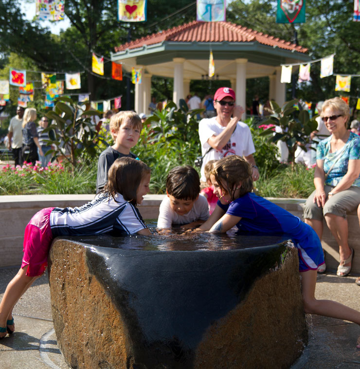 Children play by a fountain at Washington Park