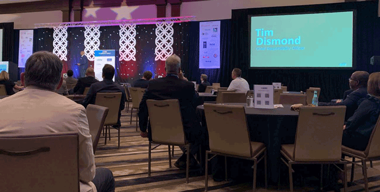 People sit at their tables for the IAMC conference