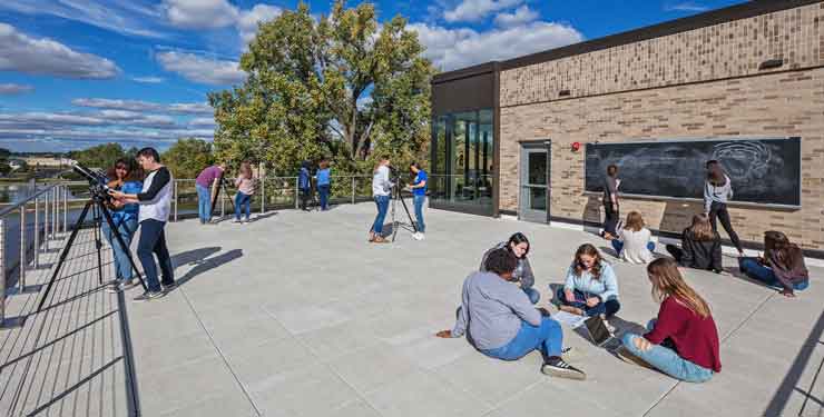 Students hang out on a rooftop terrace