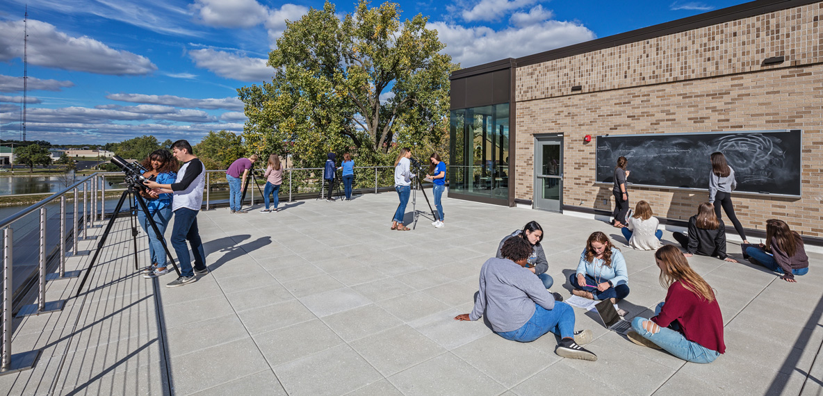 Students hang out on a rooftop terrace