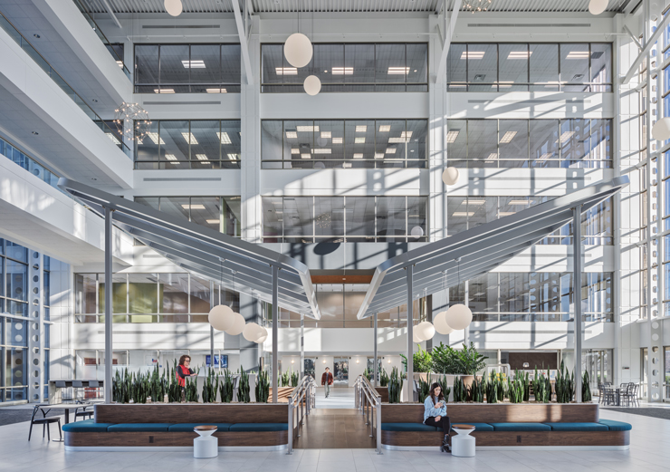 The glass atrium connects two five-story towers