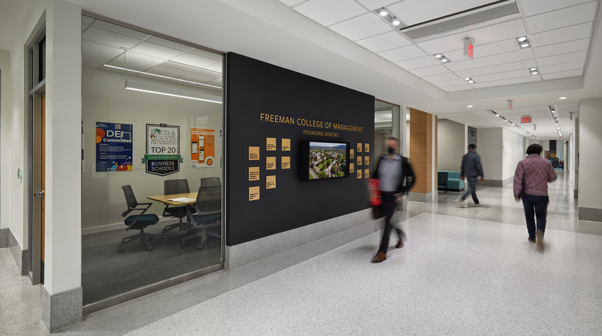 A wall calls out the university's founding donors with gold plaques