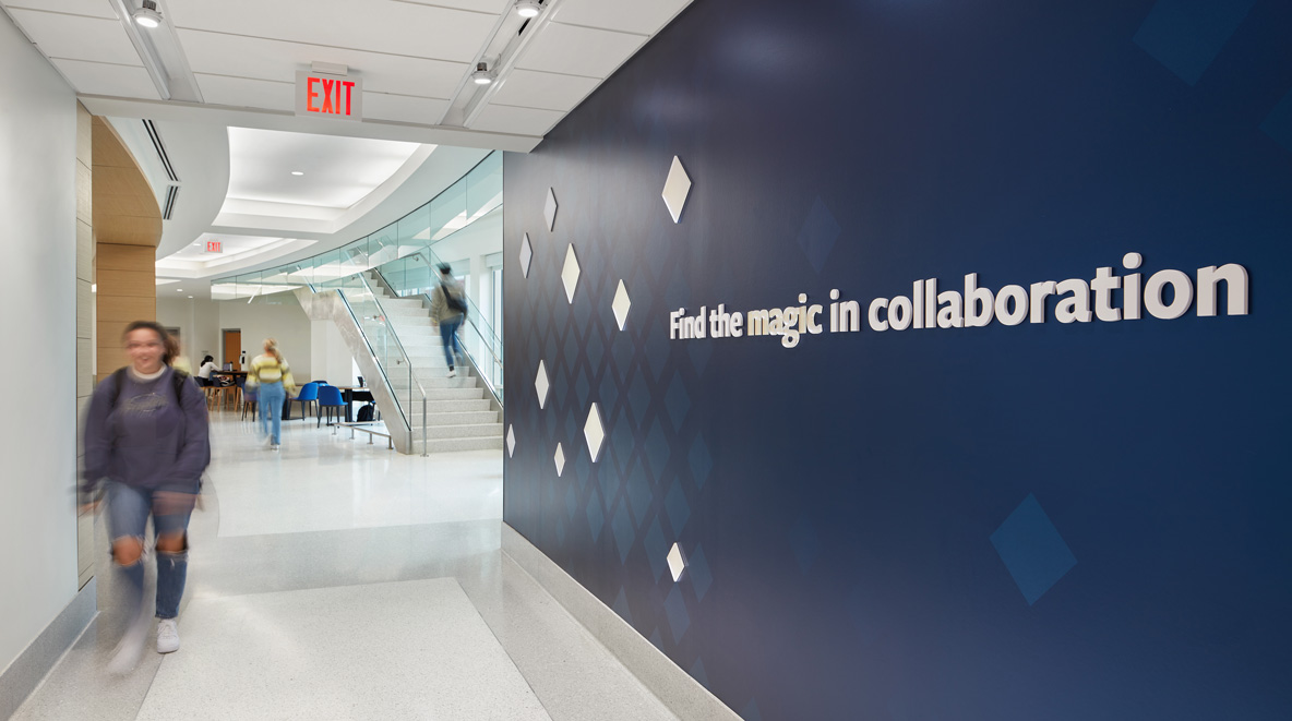 A blue wallcovering states, "Find the magic in collaboration." 