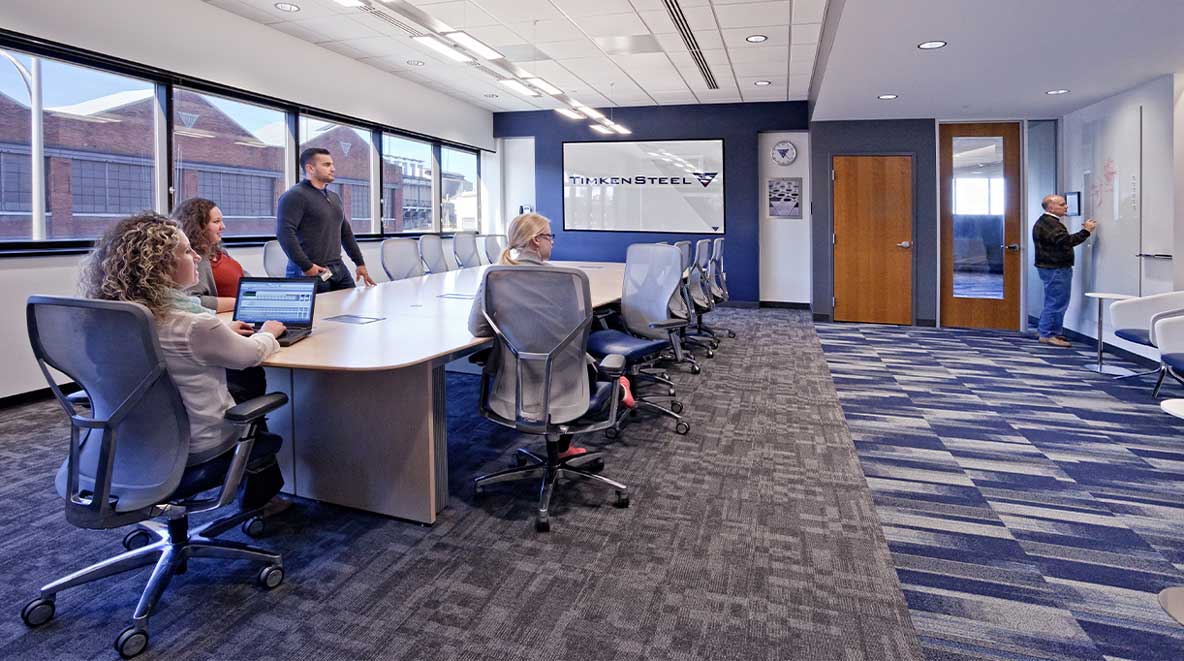 Employees gather in a conference room