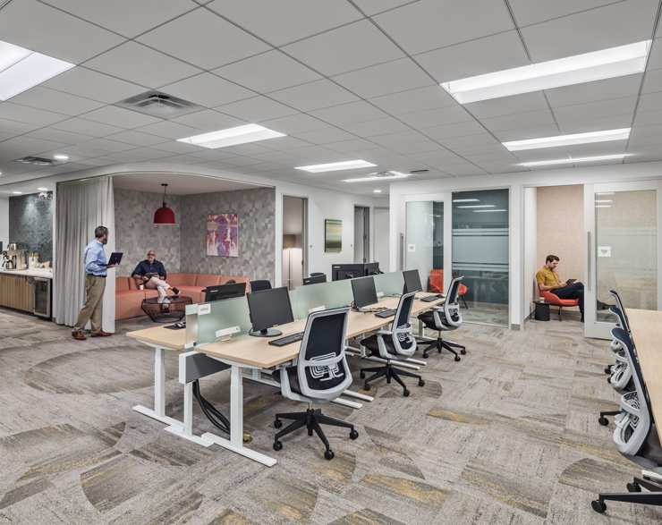 The open work environment boasts huddle rooms and collaboration nooks