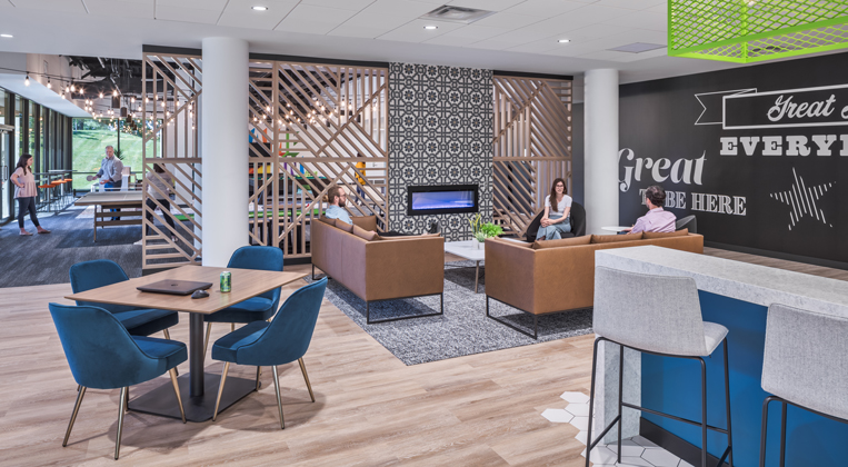 Employees sit on couches right next to a cafe