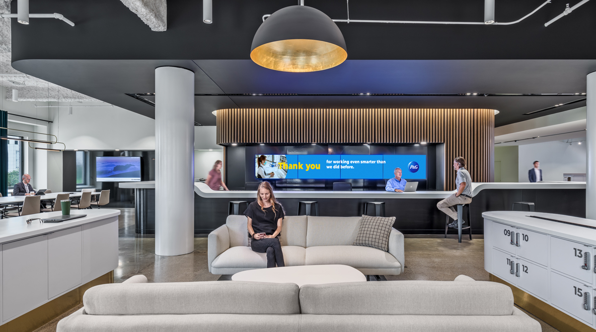 An employee sits on the couch in front of the bar