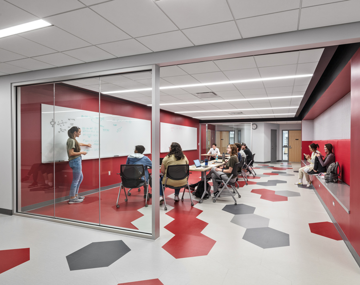 Students gather in a collaboration area adjacent to lab spaces