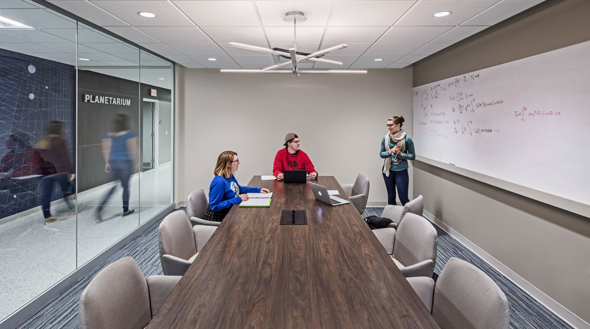 Students gather in a private meeting room to problem solve