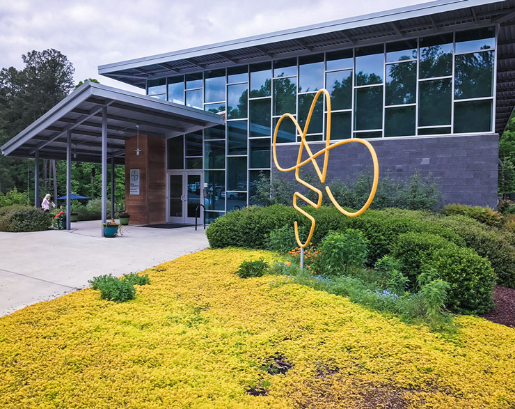 A bee-shaped piece of artwork stands at the front of the entrance